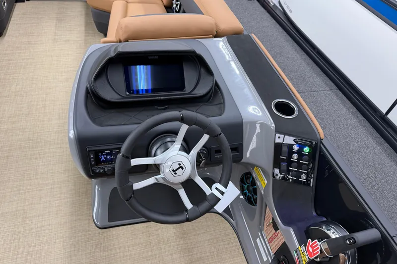 Slide: The Image of 2026 Harris Sunliner 230 boat dashboard with steering wheel, touchscreen, and control panel. - 10