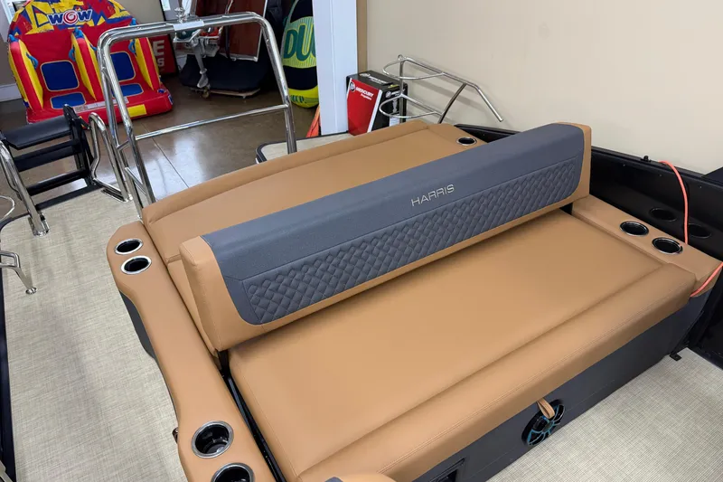 Slide: The Image of 2026 Harris Sunliner 230 boat interior with tan seating and cup holders. - 11