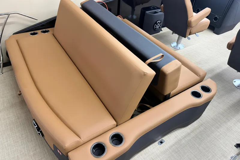 Slide: The Image of 2026 Harris Sunliner 230 boat interior with tan seating and cup holders. - 12