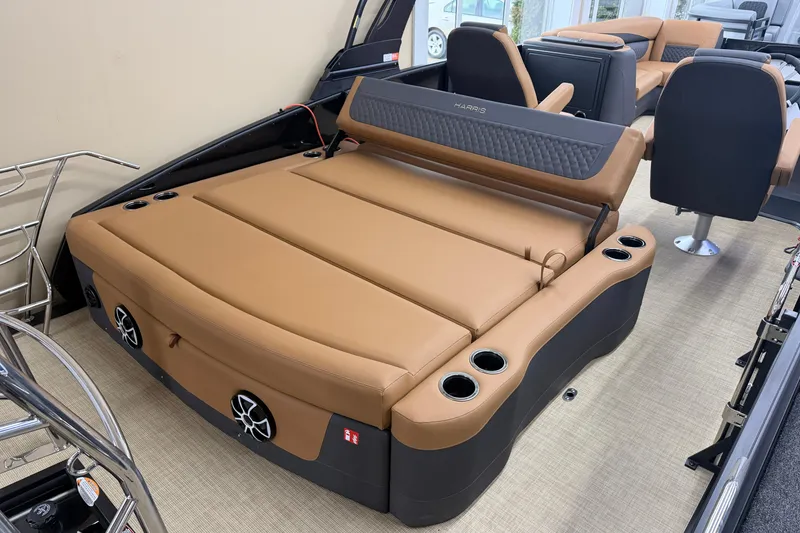 Slide: The Image of 2026 Harris Sunliner 230 boat interior with tan seating and cup holders. - 13