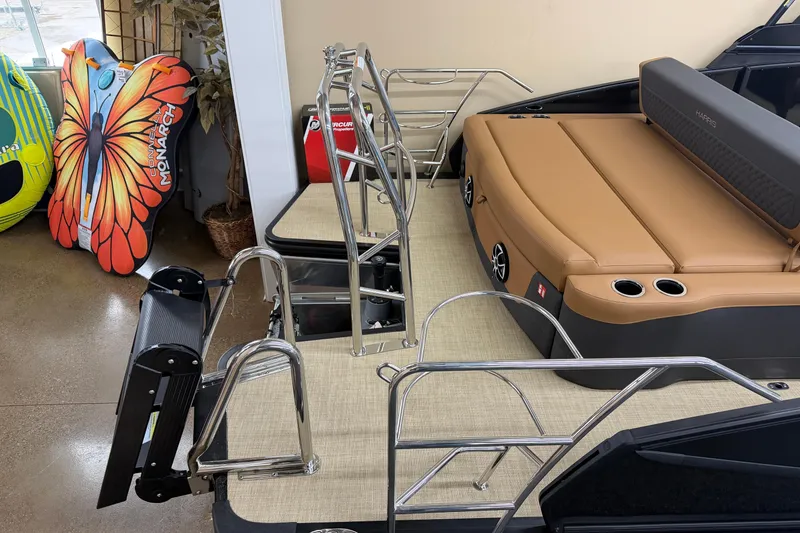 Slide: The Image of 2026 Harris Sunliner 230 boat interior with tan seating and stainless steel railings. - 16