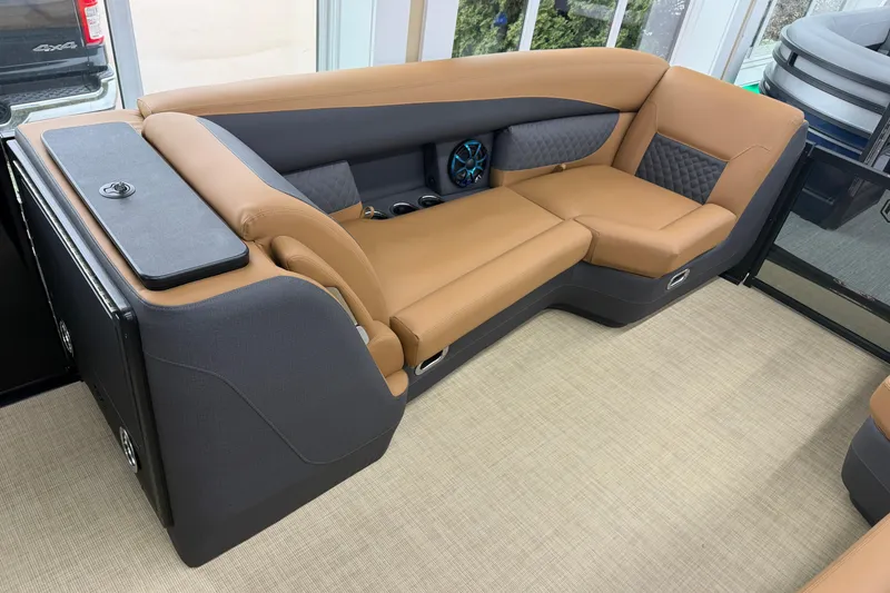 Slide: The Image of Luxurious seating in 2026 Harris Sunliner 230 boat, featuring tan and gray upholstery. - 6