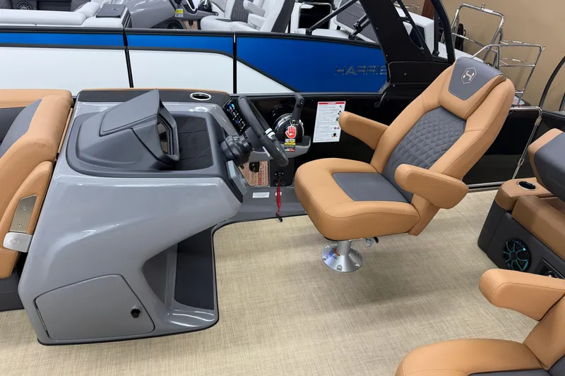 Slide: The Image of Captain's chair and helm of 2026 Harris Sunliner 230 boat, featuring modern design and controls. - 7