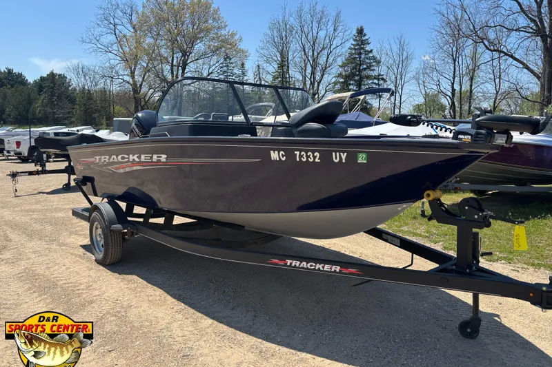 Slide: The Image of 2023 Tracker Pro Guide V-175 WT boat on trailer in outdoor setting. - 2