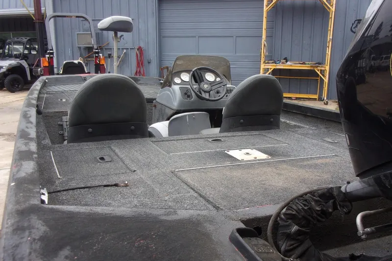 Slide: The Image of 2006 Triton TS-17 boat interior with dual seats and steering console in a garage setting. - 11