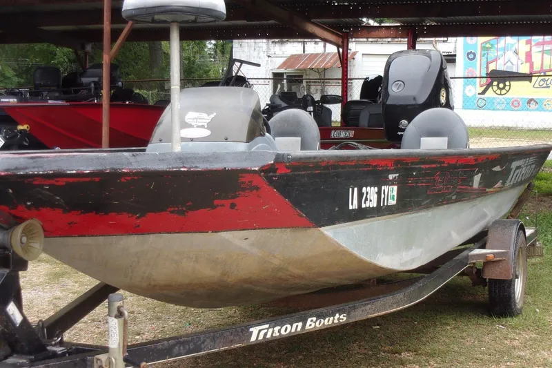 Slide: The Image of 2006 Triton TS-17 boat on trailer, parked outdoors with visible registration numbers. - 3