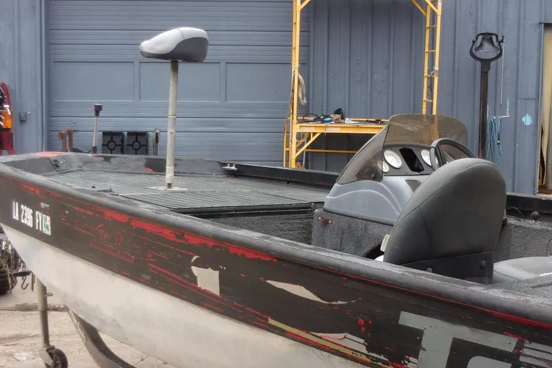 Slide: The Image of 2006 Triton TS-17 boat with seating, parked near a garage. - 4