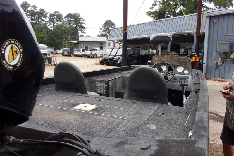 Slide: The Image of 2006 Triton TS-17 boat with US Army 1st Cavalry decal, parked outdoors near a building. - 5
