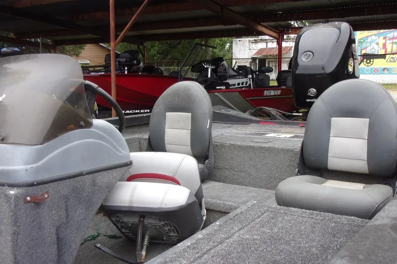 Slide: The Image of 2006 Triton TS-17 boat interior with gray seating and steering console. - 7