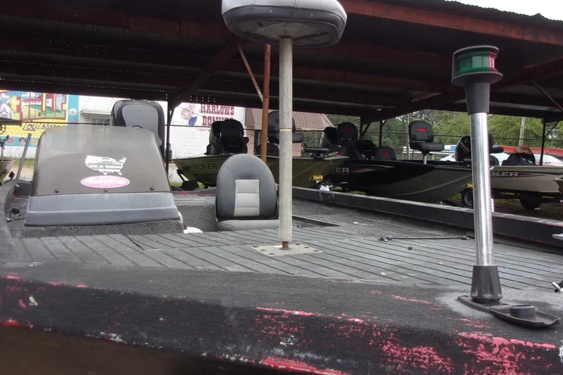 Slide: The Image of 2006 Triton TS-17 boat under shelter, featuring seating and navigation light. - 8