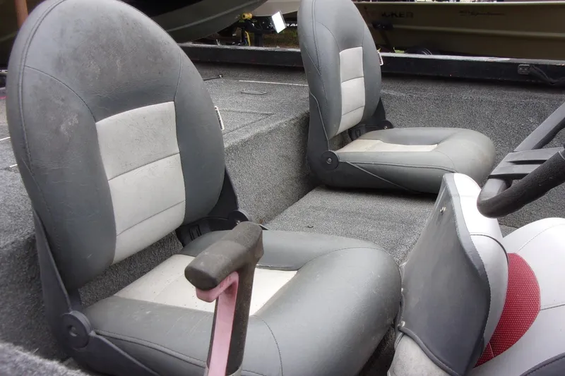 Slide: The Image of Interior of a 2006 Triton TS-17 boat featuring two gray and white seats. - 9