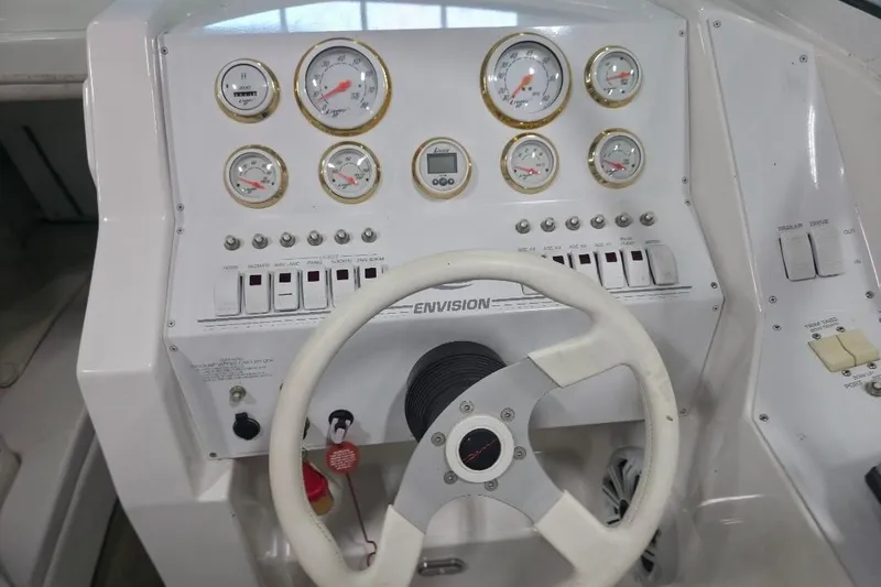 Slide: The Image of Dashboard of a 2005 Envision 2900 Combo boat with gauges and steering wheel. - 10