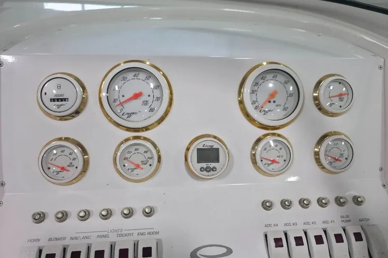 Slide: The Image of Dashboard of a 2005 Envision 2900 Combo boat with gauges and switches. - 11