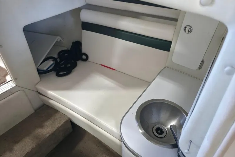 Slide: The Image of Interior of a 2005 Envision 2900 Combo boat with sink and seating area. - 13