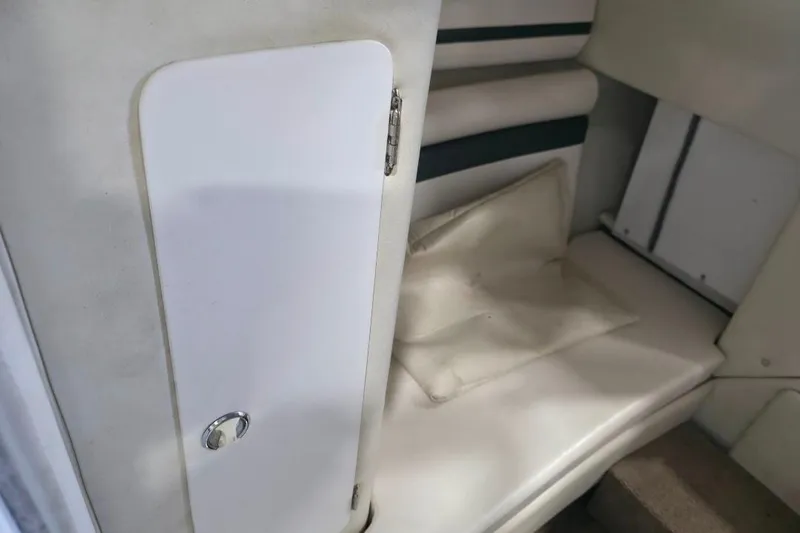 Slide: The Image of Interior cabin of 2005 Envision 2900 Combo boat with cushioned seating and storage. - 14