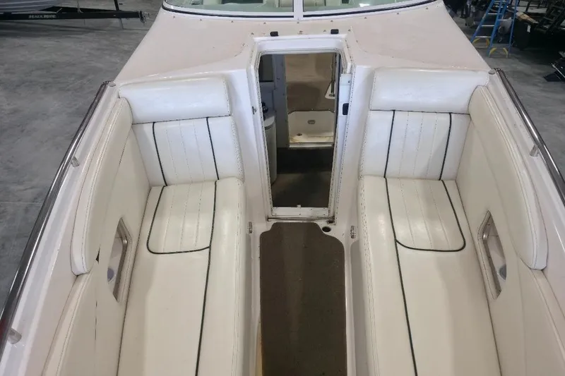 Slide: The Image of Interior view of 2005 Envision 2900 Combo boat with white seating and open cabin door. - 16