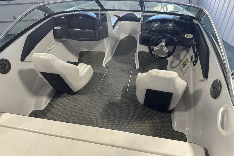 Slide: The Image of 2016 Four Winns 190 Freedom boat interior with steering wheel and seating. - 10