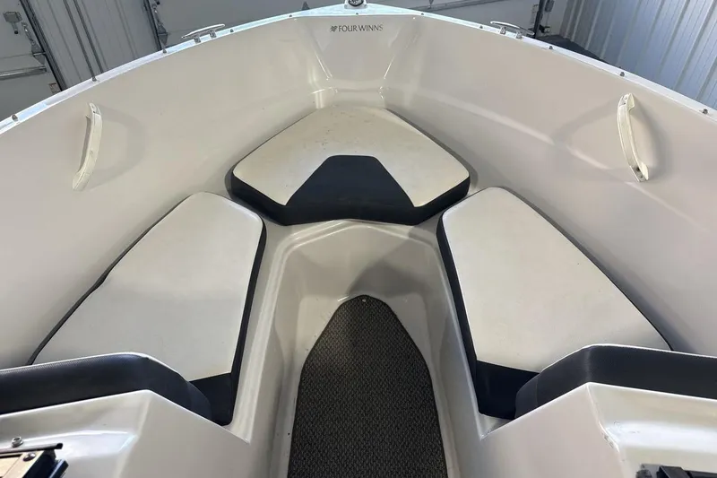 Slide: The Image of 2016 Four Winns 190 Freedom boat interior with cushioned seating and clean design. - 11