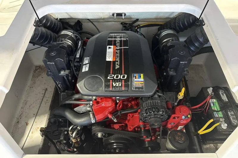 Slide: The Image of Engine compartment of a 2016 Four Winns 190 Freedom boat, featuring a V6 200 horsepower engine. - 20