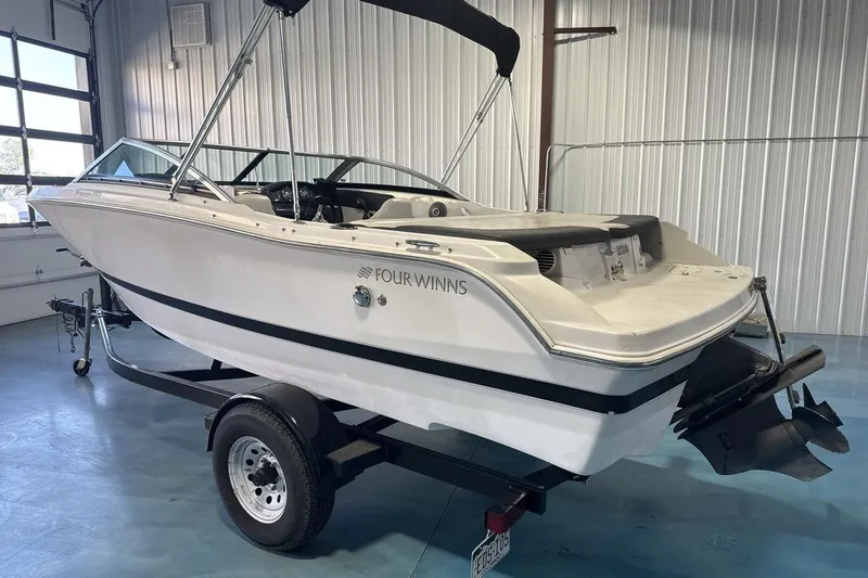 Slide: The Image of 2016 Four Winns 190 Freedom boat on trailer in indoor storage. - 3