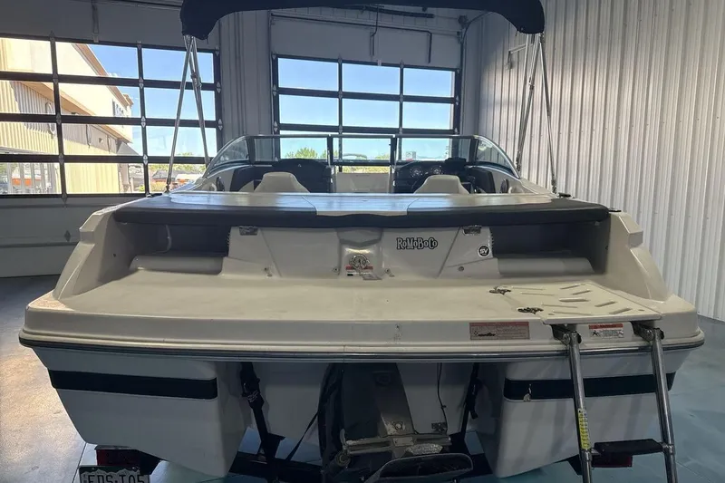 Slide: The Image of 2016 Four Winns 190 Freedom boat in a garage, rear view with swim platform. - 4