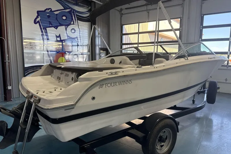 Slide: The Image of 2016 Four Winns 190 Freedom boat on trailer in indoor showroom. - 5