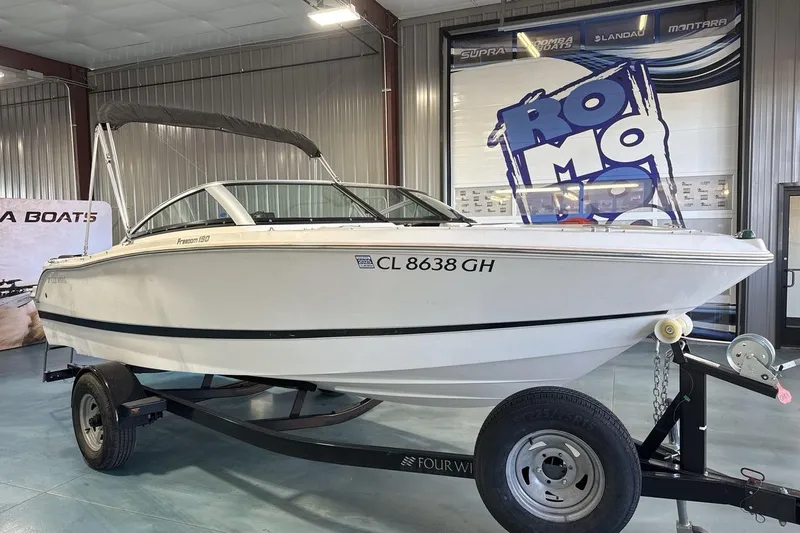 Slide: The Image of 2016 Four Winns 190 Freedom boat on trailer in showroom setting. - 7