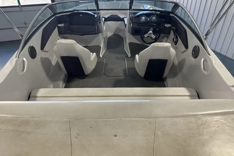 Slide: The Image of Interior of a 2016 Four Winns 190 Freedom boat, featuring seating and steering console. - 9
