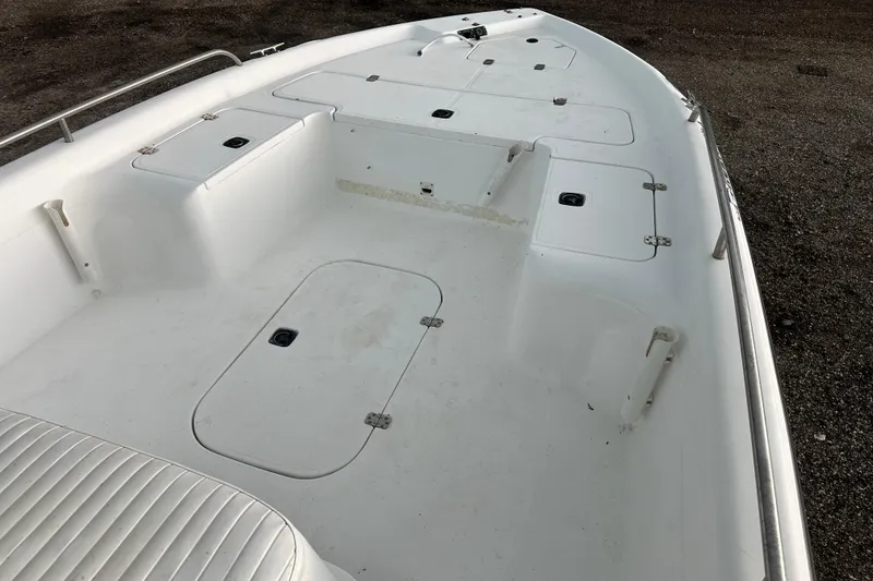 Slide: The Image of 2002 Polar 2300 Bay boat deck with storage compartments and seating. - 10