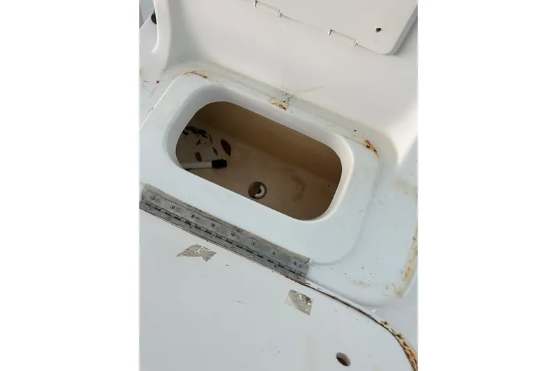 Slide: The Image of Open storage compartment on 2002 Polar 2300 Bay boat, showing interior details. - 13
