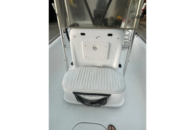 Slide: The Image of 2002 Polar 2300 Bay boat interior with white seating and console. - 14