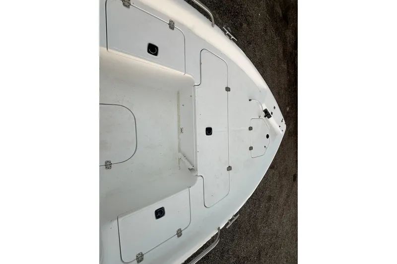 Slide: The Image of 2002 Polar 2300 Bay boat deck with storage compartments and clean white surface. - 15