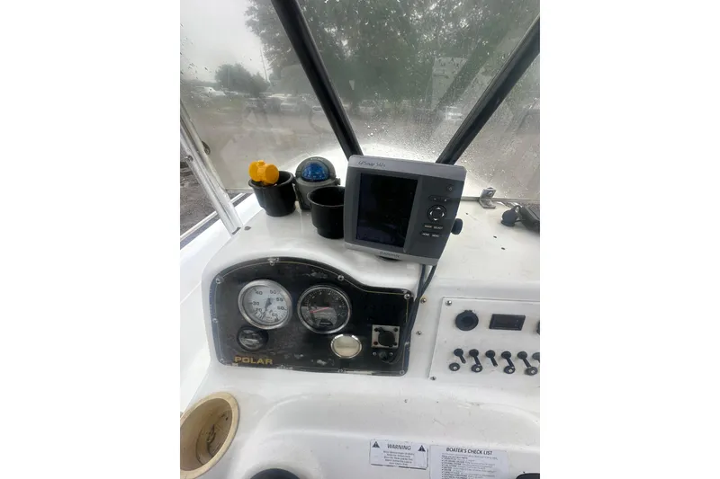 Slide: The Image of Console of a 2002 Polar 2300 Bay boat with gauges and navigation equipment. - 16