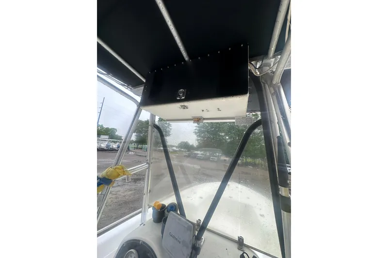 Slide: The Image of 2002 Polar 2300 Bay boat interior with navigation equipment and canopy. - 17