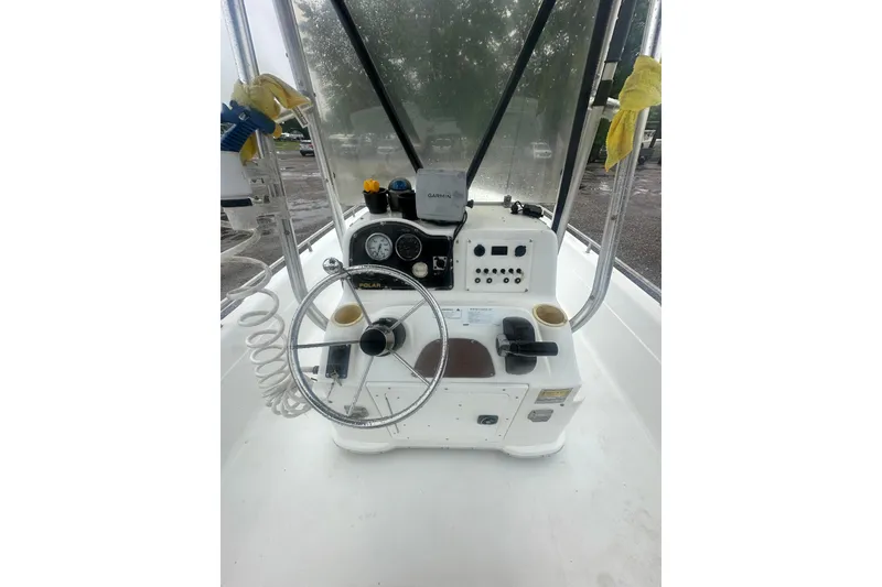 Slide: The Image of 2002 Polar 2300 Bay boat console with steering wheel and navigation equipment. - 18