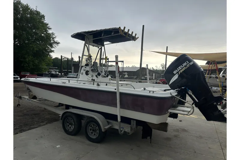 Slide: The Image of 2002 Polar 2300 Bay boat with Suzuki outboard motor on trailer. - 2