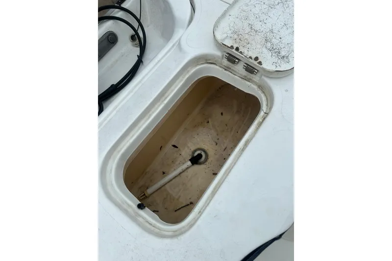 Slide: The Image of Open storage compartment on a 2002 Polar 2300 Bay boat, showing interior details. - 21