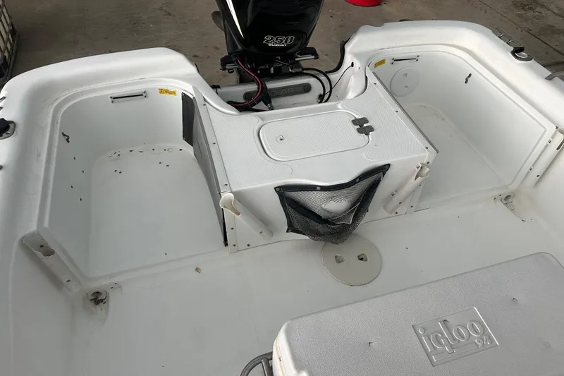 Slide: The Image of 2002 Polar 2300 Bay boat interior with storage compartments and outboard motor. - 9