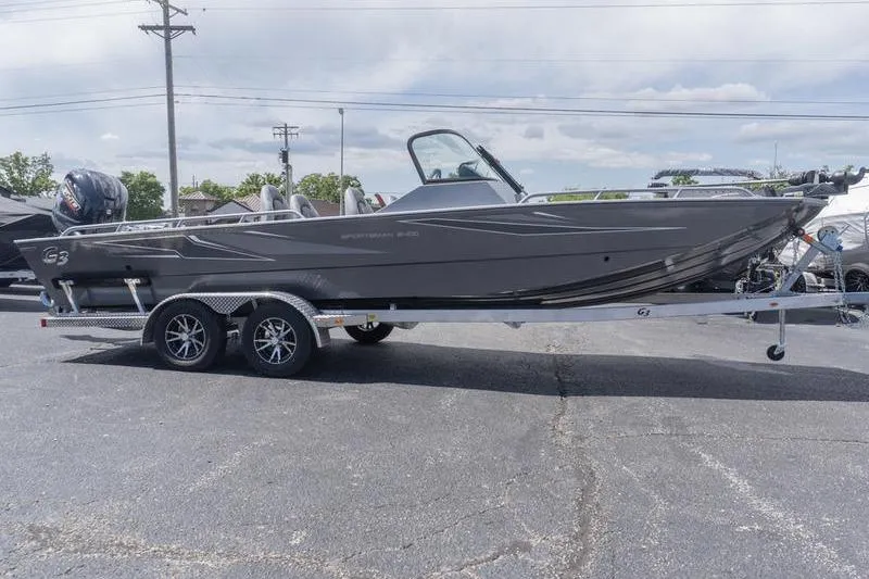The Image of 2026 G3 Sportsman 2400 boat on trailer, parked outdoors under cloudy sky. - 1
