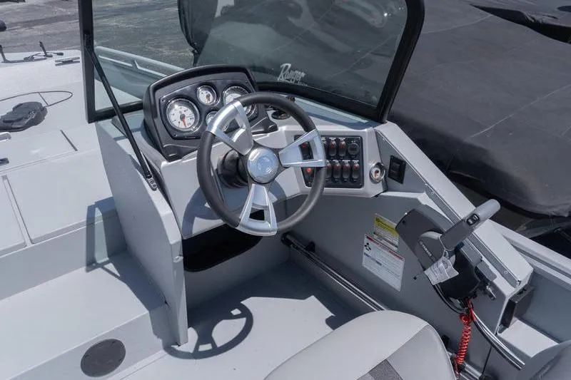 Slide: The Image of 2026 G3 Sportsman 2400 boat cockpit with steering wheel and control panel. - 10