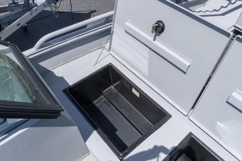 Slide: The Image of 2026 G3 Sportsman 2400 boat storage compartment with open hatch, showcasing interior space. - 11