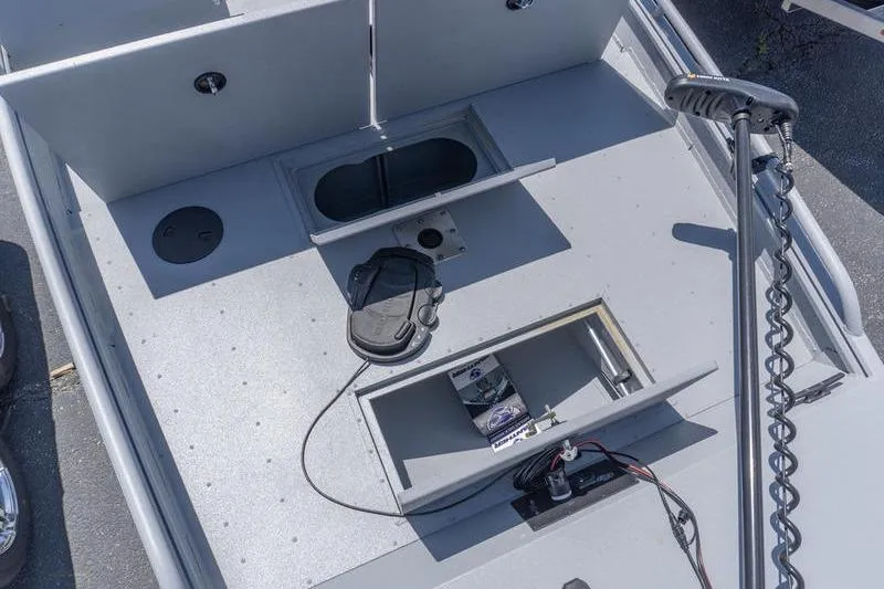 Slide: The Image of 2026 G3 Sportsman 2400 boat deck with storage compartments and trolling motor. - 13