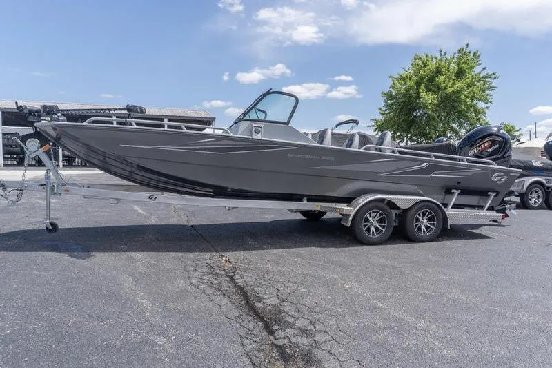 Slide: The Image of 2026 G3 Sportsman 2400 boat on trailer, parked outdoors under a clear sky. - 3