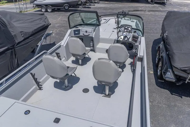 Slide: The Image of 2026 G3 Sportsman 2400 boat with four seats, steering console, and spacious deck. - 6