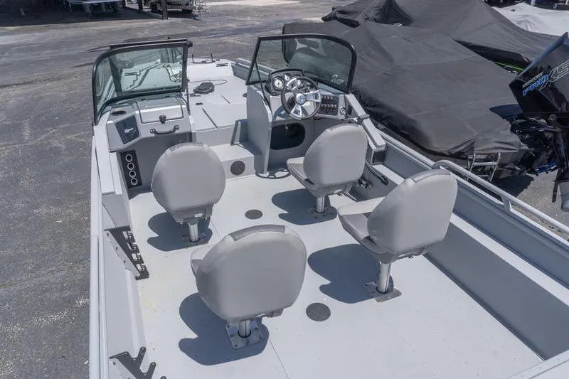 Slide: The Image of 2026 G3 Sportsman 2400 boat interior with four seats and steering console. - 7
