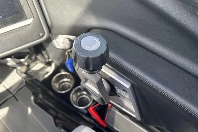 Slide: The Image of 2024 Supra SL 550 interior throttle control with cup holders and dashboard details. - 16
