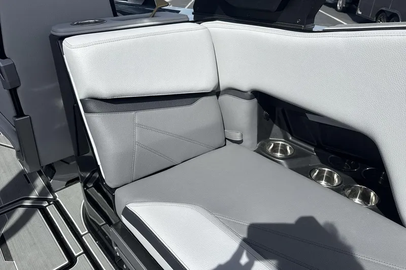 Slide: The Image of 2024 Supra SL 550 boat interior with gray seating and cup holders. - 25
