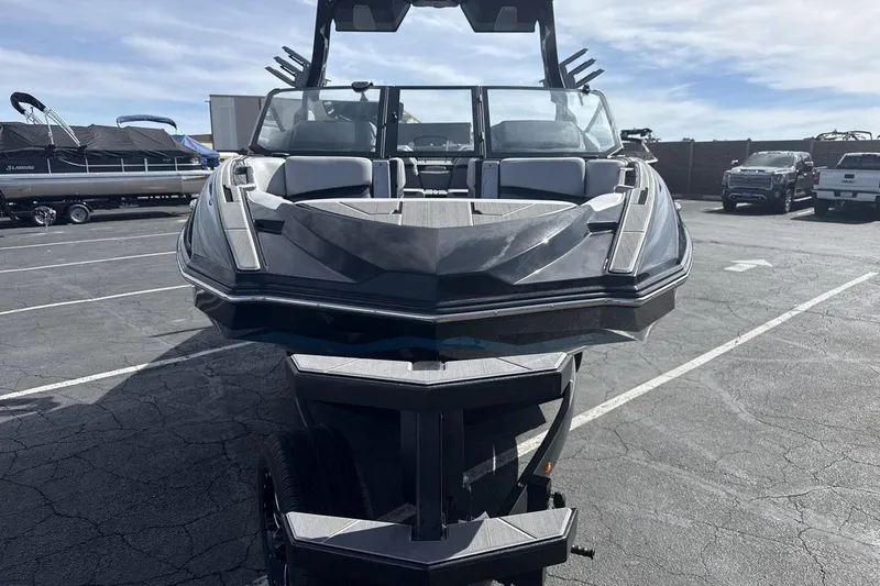 Slide: The Image of 2024 Supra SL 550 boat on trailer in parking lot, front view. - 8