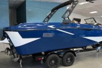 Slide: The Image of 2026 Heyday H22 boat in showroom, featuring sleek blue and white design on trailer. - 1