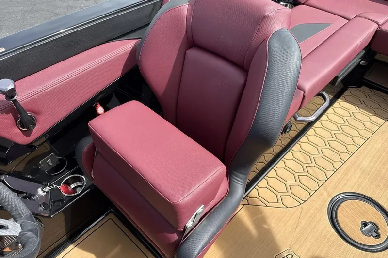 Slide: The Image of 2023 MasterCraft NXT22 interior with maroon seating and stylish flooring design. - 13